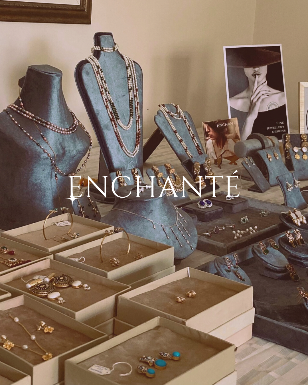 Jewelry display with 'Enchante' branding in a store setting.